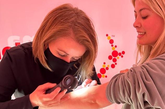 Melanoma New Zealand Nurse Educator Sue Bibby and patient having a spot checked on her arm